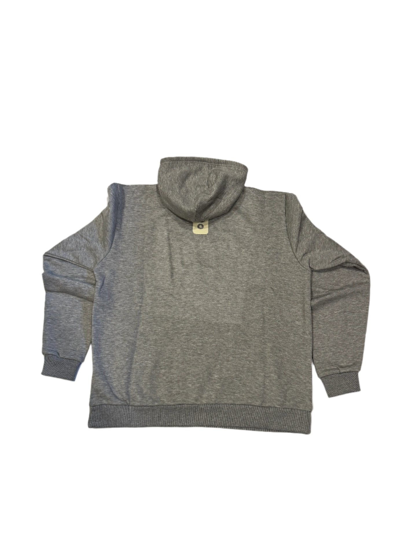 Gray hoodie on a white surface with a tiled floor background