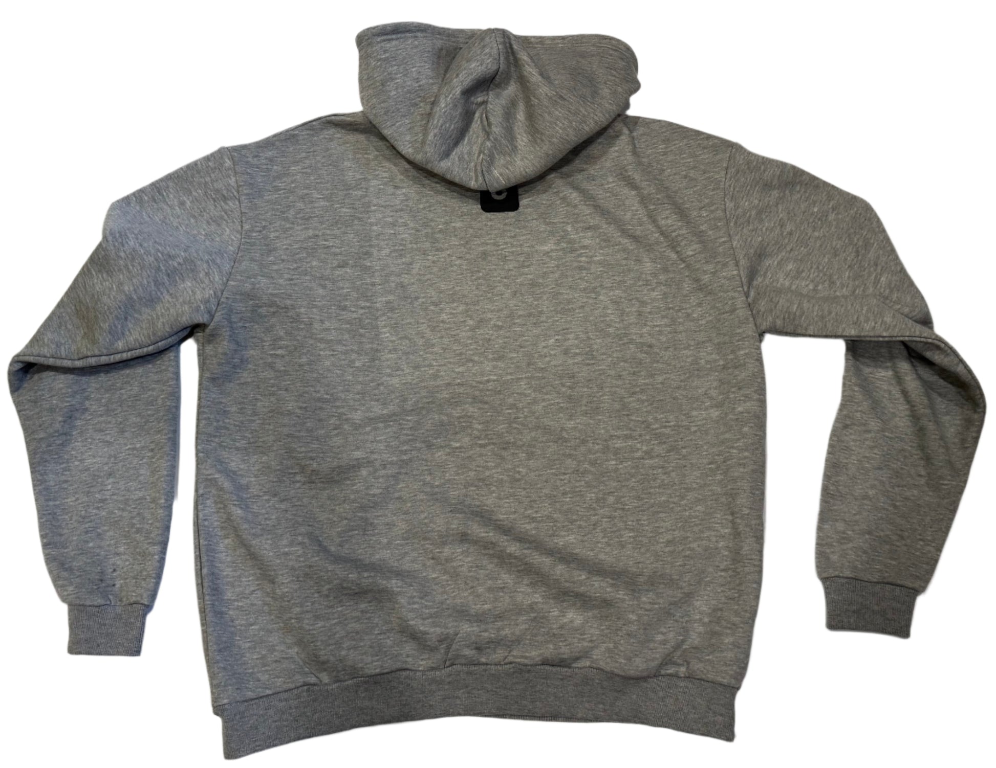 Gray hoodie on a white surface with a tiled floor background